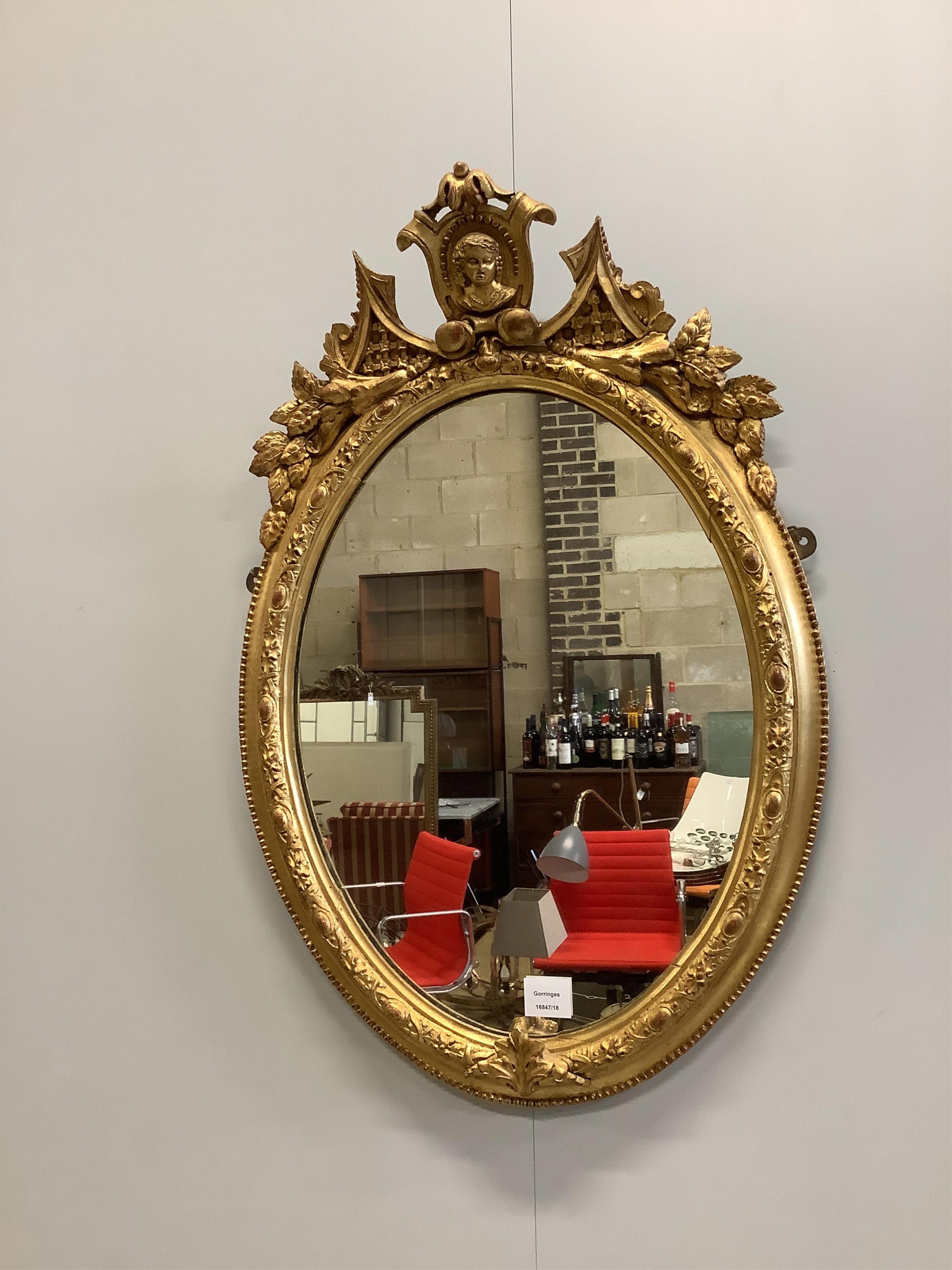 A Victorian oval giltwood and composition wall mirror, width 52cm, height 80cm. Condition - good, re-gilded